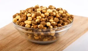 Roasted gram is a nutritious and versatile snack with numerous health benefits, including improved digestion and weight management. Roasted gram, known as roasted chana or chickpeas, is a popular legume in many cultures. It is rich in protein, fibre, vitamins, and minerals, making it an excellent snack for those looking to maintain a healthy diet. Roasted gram can help control blood sugar levels, lower cholesterol, and boost energy. Its high fibre content aids digestion and promotes a feeling of fullness, which helps in weight management. Roasted gram is also a good source of antioxidants, which protect the body from harmful free radicals. Its versatility allows it to be used in various recipes, making it a delicious and nutritious addition to any diet. Introduction To Roasted Gram Roasted gram, known as roasted chickpeas or chana, is a popular snack. It is crunchy, delicious, and packed with nutrients. This blog post explores the benefits of eating roasted gram and provides detailed insights into its origins, popularity, and nutritional profile. Origins And Popularity Roasted gram has a rich history. It originated in the Mediterranean and Middle East and has gained popularity worldwide. In India, roasted gram is a staple snack. People enjoy it for its taste and health benefits. It is easy to prepare and store, making it a convenient snack. Roasted gram is also famous in various cuisines. It can be found in salads, soups, and even desserts. Its versatility makes it a favourite among health-conscious individuals. Many cultures have their unique ways of roasting and seasoning gram. Basic Nutritional Profile Roasted gram is a powerhouse of nutrients. It is high in protein and fibre, making it an excellent snack for those looking to maintain a healthy diet. Nutrient Amount per 100g Protein 20g Fibre 12g Carbohydrates 60g Fat 6g Calories 360 Besides protein and fibre, roasted gram contains essential vitamins and minerals. It is rich in iron, magnesium, and zinc, which are crucial for overall health. They help boost immunity and improve digestion. Roasted gram is low in fat, making it a healthy snack choice. It is perfect for those who want to manage their weight. The high fiber content helps you feel full for a longer time, reducing the urge to snack on unhealthy foods. In summary, roasted gram is a nutritious and delicious snack. It offers numerous health benefits and is easy to incorporate into your diet. Weight Management Wonders Roasted gram, also known as roasted chickpeas, is a powerful snack for weight management. This humble legume is tasty and packed with nutrients that can help keep your weight in check. Explore the excellent benefits of including roasted gram in your diet for weight control. Low-calorie, High-satisfaction The most significant advantage of roasted gram is its low-calorie content. A 100-gram serving contains only around 120 calories. Yet, it provides a feeling of fullness and satisfaction, making it an excellent snack choice for those watching their calorie intake. Roasted gram is high in protein and fibre. These two components are crucial for feeling full. They help you avoid overeating and keep your calorie count in check. Below is a quick comparison table that shows the nutritional content of roasted gram Nutrient Amount per 100g Calories 120 Protein 7g Fibre 5g Role In Appetite Control Roasted gram plays a significant role in appetite control. The high fibre content slows down digestion, making you feel full longer. This helps reduce the urge for unhealthy snacking between meals. Protein is also vital in controlling appetite. It helps stabilize blood sugar levels, which is essential for managing hunger pangs. Roasted gram, rich in fibre and protein, is a perfect choice to help you stay on track with your weight management goals. Here are some quick points on how roasted gram can help in appetite control • High in dietary fibre • Contains essential proteins • Stabilizes blood sugar levels • Reduces hunger pangs Heart Health Hero Roasted gram, or chana, is a superfood with numerous benefits. It plays a significant role in promoting heart health. This crunchy legume helps reduce bad cholesterol and maintain blood pressure. Here are the key reasons why roasted gram is a heart health hero. Reducing Bad Cholesterol Roasted gram is rich in dietary fibre, essential for lowering harmful cholesterol levels (LDL). Consuming roasted gram regularly helps remove excess cholesterol from the body and boosts the production of good cholesterol (HDL). This balance is crucial for heart health. Moreover, roasted gram is low in saturated fats, which increases harmful cholesterol levels. Replacing high-fat snacks with roasted gram can make a big difference. This simple change supports a healthier heart. Blood Pressure Benefits Roasted gram contains significant amounts of potassium, which helps control blood pressure. High blood pressure puts extra strain on the heart, so consuming potassium-rich foods like roasted gram can help maintain a healthy blood pressure level. Additionally, roasted gram is low in sodium. High sodium levels can raise blood pressure. By choosing low-sodium snacks, you support your heart health. Roasted gram is an excellent option for this purpose. Nutrient Benefit Fibre Reduces bad cholesterol Potassium Regulates blood pressure Low Sodium Prevents high blood pressure Low Saturated Fats Supports good cholesterol levels Digestive System Support Eating roasted gram can significantly support your digestive health. The nutrients in roasted gram help maintain a healthy gut. They also aid in preventing various digestive issues. Let's explore how roasted gram can benefit your digestive system. High Fiber Content Roasted gram is rich in dietary fibre, which plays a crucial role in digestion. Fibre adds bulk to the stool, making it easier to pass. This helps in regular bowel movements and prevents constipation. A single serving of roasted gram can provide a good amount of fibre. Nutrient Amount per 100g Dietary Fiber 12 grams Including roasted gram can meet your daily fibre needs and improve your digestive health. Preventing Digestive Disorders Roasted gram contains essential nutrients that help in preventing digestive disorders. These nutrients include vitamins, minerals, and antioxidants. They work together to keep your digestive system healthy. • Vitamins support the overall function of the digestive tract. • Minerals like magnesium aid in muscle function, including the digestive tract muscles. • Antioxidants protect the gut lining from damage. You can reduce the risk of common digestive issues by consuming roasted gram. These include indigestion, bloating, and acid reflux. The nutrients in roasted gram make it a powerful food for digestive health. Energy Booster Roasted gram is a fantastic energy booster. This humble legume packs a punch, releasing quick and sustained energy. It's a perfect snack for those on the go or athletes needing a quick pick-me-up. Sustained Energy Release Roasted gram offers a steady supply of energy. It contains complex carbohydrates and protein, which digest slowly, providing sustained energy over time. This helps you stay active and alert throughout the day. Here’s a quick breakdown of its nutritional profile Nutrient Amount (per 100g) Protein 20g Carbohydrates 60g Fibre 18g Fat 6g These nutrients help maintain blood sugar levels. This prevents energy spikes and crashes. Ideal Snack For Athletes Athletes need energy-rich snacks. Roasted gram fits this requirement perfectly. It provides a balanced mix of protein and carbs. This helps in muscle repair and energy replenishment after a workout. Benefits for athletes include • Quick recovery post-exercise • Enhanced stamina and endurance • Reduced muscle fatigue Roasted gram is also lightweight and easy to carry, making it an ideal snack for athletes on the move. Incorporate roasted gram into your diet. Experience a natural and wholesome energy boost! Blood Sugar Balancer Roasted gram, also known as roasted chickpeas, offers numerous health benefits. One significant benefit is its ability to balance blood sugar levels, making it an excellent addition to the diet for those monitoring their blood sugar levels. Low Glycemic Index Roasted gram has a low glycemic index (GI), slowly releasing sugar into the bloodstream. This helps maintain steady blood sugar levels. A low GI diet is beneficial for everyone, especially those with diabetes. Here is a quick comparison of glycemic index values Food Item Glycemic Index (GI) Roasted Gram 28 White Bread 75 Brown Rice 50 Managing Diabetes Roasted gram is an excellent food for managing diabetes. Its low GI value helps in controlling blood sugar spikes. Including roasted gram in your diet can help you manage diabetes more effectively. Here are some tips for including roasted gram in your diet • Add roasted gram to salads for a crunchy texture. • Use it as a topping for soups. • Snack on roasted gram instead of unhealthy snacks. Roasted gram is delicious and incredibly beneficial for blood sugar control. Make it a part of your daily diet to enjoy its health benefits. Muscle And Bone Strength Eating roasted gram offers numerous benefits for muscle and bone strength. This nutritious snack is packed with essential nutrients that support muscle repair and bone density. Below, we explore two critical nutrients in roasted gram that contribute to these benefits. Protein For Muscle Repair Protein is essential for muscle repair and growth. Roasted gram is rich in protein, making it an excellent snack for muscle health. Consuming protein helps repair muscle tissues after exercise or physical activity. Nutrient Benefits Protein Repairs muscle tissues, supports growth, enhances strength Including roasted gram in your diet provides the protein needed for muscle maintenance. This helps you stay strong and active. Calcium For Bone Density Calcium is crucial for maintaining bone density. Roasted gram contains a good amount of calcium, which supports bone health. Strong bones are essential for overall mobility and preventing fractures. • Strengthens bones • Prevents bone-related diseases • Enhances overall bone health Eating roasted gram regularly can help you maintain healthy bones, making it a valuable addition to your diet. Natural Detoxification Roasted gram, also known as chana, is a superfood. It offers numerous health benefits, one of which is natural detoxification. This small yet powerful legume can help cleanse your body, effectively removing toxins and impurities. Antioxidant Properties Roasted gram is rich in antioxidants, which fight free radicals in your body. Free radicals can cause cell damage and lead to diseases. Eating roasted gram helps neutralize these harmful elements, aiding in detoxifying your system naturally. Liver Health The liver plays a crucial role in detoxification. Consuming roasted gram supports liver health. It contains essential nutrients that boost liver function. A healthy liver filters out toxins more efficiently. This makes roasted gram an excellent addition to your diet for natural detoxification. Benefits Details Antioxidants Neutralize free radicals Liver Support Enhances liver function • Boosts immune system • Improves digestion • Reduces inflammation 1. Eat a handful daily. 2. Mix with salads. 3. Add to smoothies. Incorporate roasted gram into your daily diet. Experience the detoxifying benefits and feel rejuvenated. Skin And Hair Health Roasted gram is more than just a tasty snack. It offers many benefits for your skin and hair. Including roasted gram can lead to healthier skin and stronger hair. Nutrients For Skin Elasticity Roasted gram is rich in protein, which helps to maintain skin elasticity. Your skin needs protein to stay firm and youthful. The high protein content in roasted gram supports collagen production. Collagen is essential for keeping your skin tight and smooth. Roasted gram contains vitamins like Vitamin C. Vitamin C is a powerful antioxidant. It helps to reduce wrinkles and fine lines. Antioxidants protect your skin from damage caused by free radicals. Another critical nutrient in roasted gram is Vitamin E. Vitamin E helps moisturize skin and improves texture and tone. Regular intake of a roasted gram can make skin look radiant and healthy. Strengthens Hair Roasted gram contains iron, which is vital for hair health. Iron helps to improve blood circulation to the scalp. Good blood flow ensures that your hair follicles receive enough nutrients. Roasted gram is also a great source of zinc. Zinc plays a crucial role in hair tissue growth and repair. It keeps the oil glands around your hair follicles working properly. Protein in roasted gram strengthens your hair from the root. Strong hair roots reduce hair fall and promote hair growth. Regular consumption of roasted gram can result in thick and shiny hair. Biotin is another essential nutrient found in roasted gram. It helps prevent hair thinning and breakage and supports hair's overall health. Nutrient Skin Benefits Hair Benefits Protein Maintains elasticity Strengthens roots Vitamin C Reduces wrinkles Improves scalp health Vitamin E Moisturizes skin Enhances texture Iron Supports collagen Boosts blood circulation Zinc Protects skin cells Promotes growth Biotin Improves complexion Prevents thinning Incorporating Roasted Gram Into Your Diet Roasted gram, or roasted chickpeas or chana, is a nutritious snack packed with protein, fibre, and essential vitamins. Adding roasted grams to your daily diet can boost your overall health. Here are easy ways to include them in your meals. Easy Recipes Roasted gram can be used in a variety of recipes. Here are some simple and tasty options • Roasted Gram Salad Mix roasted gram with chopped tomatoes, cucumbers, and onions. Add lemon juice, salt, and pepper for flavour. • Roasted Gram Chutney Blend roasted gram with garlic, green chillies, and coriander leaves. Add salt and a bit of water to make a smooth chutney. • Gram Smoothie Blend roasted gram with yoghurt, honey, and banana for a protein-packed smoothie. These recipes are quick and easy to prepare. They also make healthy and delicious meals or snacks. Daily Intake Recommendations To reap the health benefits of roasted gram, follow these daily intake recommendations • Snack Enjoy 14 cup of roasted gram as a mid-morning snack. • Meal Addition Add two tablespoons of roasted gram to your salads or soups. • Smoothies Include 14 cup of roasted gram in your breakfast smoothie. These small additions can make a big difference. They help meet your daily nutritional needs. Meal Roasted Gram Portion Breakfast 14 cup in smoothie Lunch Two tablespoons in salad Snack 14 cup as a snack By following these guidelines, you can easily incorporate roasted gram into your diet and ensure that you get its full health benefits. Conclusion Roasted gram offers numerous health benefits, making it a great addition to your diet. It boosts energy, aids digestion, and supports weight management. Incorporate roasted gram into your meals for improved overall health. Visit Wellhealthorganic. Explore more about healthy eating and wellness tips. Enjoy the benefits of roasted gram today!