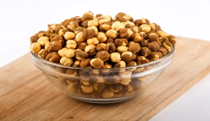 Roasted gram is a nutritious and versatile snack with numerous health benefits, including improved digestion and weight management. Roasted gram, known as roasted chana or chickpeas, is a popular legume in many cultures. It is rich in protein, fibre, vitamins, and minerals, making it an excellent snack for those looking to maintain a healthy diet. Roasted gram can help control blood sugar levels, lower cholesterol, and boost energy. Its high fibre content aids digestion and promotes a feeling of fullness, which helps in weight management. Roasted gram is also a good source of antioxidants, which protect the body from harmful free radicals. Its versatility allows it to be used in various recipes, making it a delicious and nutritious addition to any diet. Introduction To Roasted Gram Roasted gram, known as roasted chickpeas or chana, is a popular snack. It is crunchy, delicious, and packed with nutrients. This blog post explores the benefits of eating roasted gram and provides detailed insights into its origins, popularity, and nutritional profile. Origins And Popularity Roasted gram has a rich history. It originated in the Mediterranean and Middle East and has gained popularity worldwide. In India, roasted gram is a staple snack. People enjoy it for its taste and health benefits. It is easy to prepare and store, making it a convenient snack. Roasted gram is also famous in various cuisines. It can be found in salads, soups, and even desserts. Its versatility makes it a favourite among health-conscious individuals. Many cultures have their unique ways of roasting and seasoning gram. Basic Nutritional Profile Roasted gram is a powerhouse of nutrients. It is high in protein and fibre, making it an excellent snack for those looking to maintain a healthy diet. Nutrient Amount per 100g Protein 20g Fibre 12g Carbohydrates 60g Fat 6g Calories 360 Besides protein and fibre, roasted gram contains essential vitamins and minerals. It is rich in iron, magnesium, and zinc, which are crucial for overall health. They help boost immunity and improve digestion. Roasted gram is low in fat, making it a healthy snack choice. It is perfect for those who want to manage their weight. The high fiber content helps you feel full for a longer time, reducing the urge to snack on unhealthy foods. In summary, roasted gram is a nutritious and delicious snack. It offers numerous health benefits and is easy to incorporate into your diet. Weight Management Wonders Roasted gram, also known as roasted chickpeas, is a powerful snack for weight management. This humble legume is tasty and packed with nutrients that can help keep your weight in check. Explore the excellent benefits of including roasted gram in your diet for weight control. Low-calorie, High-satisfaction The most significant advantage of roasted gram is its low-calorie content. A 100-gram serving contains only around 120 calories. Yet, it provides a feeling of fullness and satisfaction, making it an excellent snack choice for those watching their calorie intake. Roasted gram is high in protein and fibre. These two components are crucial for feeling full. They help you avoid overeating and keep your calorie count in check. Below is a quick comparison table that shows the nutritional content of roasted gram Nutrient Amount per 100g Calories 120 Protein 7g Fibre 5g Role In Appetite Control Roasted gram plays a significant role in appetite control. The high fibre content slows down digestion, making you feel full longer. This helps reduce the urge for unhealthy snacking between meals. Protein is also vital in controlling appetite. It helps stabilize blood sugar levels, which is essential for managing hunger pangs. Roasted gram, rich in fibre and protein, is a perfect choice to help you stay on track with your weight management goals. Here are some quick points on how roasted gram can help in appetite control • High in dietary fibre • Contains essential proteins • Stabilizes blood sugar levels • Reduces hunger pangs Heart Health Hero Roasted gram, or chana, is a superfood with numerous benefits. It plays a significant role in promoting heart health. This crunchy legume helps reduce bad cholesterol and maintain blood pressure. Here are the key reasons why roasted gram is a heart health hero. Reducing Bad Cholesterol Roasted gram is rich in dietary fibre, essential for lowering harmful cholesterol levels (LDL). Consuming roasted gram regularly helps remove excess cholesterol from the body and boosts the production of good cholesterol (HDL). This balance is crucial for heart health. Moreover, roasted gram is low in saturated fats, which increases harmful cholesterol levels. Replacing high-fat snacks with roasted gram can make a big difference. This simple change supports a healthier heart. Blood Pressure Benefits Roasted gram contains significant amounts of potassium, which helps control blood pressure. High blood pressure puts extra strain on the heart, so consuming potassium-rich foods like roasted gram can help maintain a healthy blood pressure level. Additionally, roasted gram is low in sodium. High sodium levels can raise blood pressure. By choosing low-sodium snacks, you support your heart health. Roasted gram is an excellent option for this purpose. Nutrient Benefit Fibre Reduces bad cholesterol Potassium Regulates blood pressure Low Sodium Prevents high blood pressure Low Saturated Fats Supports good cholesterol levels Digestive System Support Eating roasted gram can significantly support your digestive health. The nutrients in roasted gram help maintain a healthy gut. They also aid in preventing various digestive issues. Let's explore how roasted gram can benefit your digestive system. High Fiber Content Roasted gram is rich in dietary fibre, which plays a crucial role in digestion. Fibre adds bulk to the stool, making it easier to pass. This helps in regular bowel movements and prevents constipation. A single serving of roasted gram can provide a good amount of fibre. Nutrient Amount per 100g Dietary Fiber 12 grams Including roasted gram can meet your daily fibre needs and improve your digestive health. Preventing Digestive Disorders Roasted gram contains essential nutrients that help in preventing digestive disorders. These nutrients include vitamins, minerals, and antioxidants. They work together to keep your digestive system healthy. • Vitamins support the overall function of the digestive tract. • Minerals like magnesium aid in muscle function, including the digestive tract muscles. • Antioxidants protect the gut lining from damage. You can reduce the risk of common digestive issues by consuming roasted gram. These include indigestion, bloating, and acid reflux. The nutrients in roasted gram make it a powerful food for digestive health. Energy Booster Roasted gram is a fantastic energy booster. This humble legume packs a punch, releasing quick and sustained energy. It's a perfect snack for those on the go or athletes needing a quick pick-me-up. Sustained Energy Release Roasted gram offers a steady supply of energy. It contains complex carbohydrates and protein, which digest slowly, providing sustained energy over time. This helps you stay active and alert throughout the day. Here’s a quick breakdown of its nutritional profile Nutrient Amount (per 100g) Protein 20g Carbohydrates 60g Fibre 18g Fat 6g These nutrients help maintain blood sugar levels. This prevents energy spikes and crashes. Ideal Snack For Athletes Athletes need energy-rich snacks. Roasted gram fits this requirement perfectly. It provides a balanced mix of protein and carbs. This helps in muscle repair and energy replenishment after a workout. Benefits for athletes include • Quick recovery post-exercise • Enhanced stamina and endurance • Reduced muscle fatigue Roasted gram is also lightweight and easy to carry, making it an ideal snack for athletes on the move. Incorporate roasted gram into your diet. Experience a natural and wholesome energy boost! Blood Sugar Balancer Roasted gram, also known as roasted chickpeas, offers numerous health benefits. One significant benefit is its ability to balance blood sugar levels, making it an excellent addition to the diet for those monitoring their blood sugar levels. Low Glycemic Index Roasted gram has a low glycemic index (GI), slowly releasing sugar into the bloodstream. This helps maintain steady blood sugar levels. A low GI diet is beneficial for everyone, especially those with diabetes. Here is a quick comparison of glycemic index values Food Item Glycemic Index (GI) Roasted Gram 28 White Bread 75 Brown Rice 50 Managing Diabetes Roasted gram is an excellent food for managing diabetes. Its low GI value helps in controlling blood sugar spikes. Including roasted gram in your diet can help you manage diabetes more effectively. Here are some tips for including roasted gram in your diet • Add roasted gram to salads for a crunchy texture. • Use it as a topping for soups. • Snack on roasted gram instead of unhealthy snacks. Roasted gram is delicious and incredibly beneficial for blood sugar control. Make it a part of your daily diet to enjoy its health benefits. Muscle And Bone Strength Eating roasted gram offers numerous benefits for muscle and bone strength. This nutritious snack is packed with essential nutrients that support muscle repair and bone density. Below, we explore two critical nutrients in roasted gram that contribute to these benefits. Protein For Muscle Repair Protein is essential for muscle repair and growth. Roasted gram is rich in protein, making it an excellent snack for muscle health. Consuming protein helps repair muscle tissues after exercise or physical activity. Nutrient Benefits Protein Repairs muscle tissues, supports growth, enhances strength Including roasted gram in your diet provides the protein needed for muscle maintenance. This helps you stay strong and active. Calcium For Bone Density Calcium is crucial for maintaining bone density. Roasted gram contains a good amount of calcium, which supports bone health. Strong bones are essential for overall mobility and preventing fractures. • Strengthens bones • Prevents bone-related diseases • Enhances overall bone health Eating roasted gram regularly can help you maintain healthy bones, making it a valuable addition to your diet. Natural Detoxification Roasted gram, also known as chana, is a superfood. It offers numerous health benefits, one of which is natural detoxification. This small yet powerful legume can help cleanse your body, effectively removing toxins and impurities. Antioxidant Properties Roasted gram is rich in antioxidants, which fight free radicals in your body. Free radicals can cause cell damage and lead to diseases. Eating roasted gram helps neutralize these harmful elements, aiding in detoxifying your system naturally. Liver Health The liver plays a crucial role in detoxification. Consuming roasted gram supports liver health. It contains essential nutrients that boost liver function. A healthy liver filters out toxins more efficiently. This makes roasted gram an excellent addition to your diet for natural detoxification. Benefits Details Antioxidants Neutralize free radicals Liver Support Enhances liver function • Boosts immune system • Improves digestion • Reduces inflammation 1. Eat a handful daily. 2. Mix with salads. 3. Add to smoothies. Incorporate roasted gram into your daily diet. Experience the detoxifying benefits and feel rejuvenated. Skin And Hair Health Roasted gram is more than just a tasty snack. It offers many benefits for your skin and hair. Including roasted gram can lead to healthier skin and stronger hair. Nutrients For Skin Elasticity Roasted gram is rich in protein, which helps to maintain skin elasticity. Your skin needs protein to stay firm and youthful. The high protein content in roasted gram supports collagen production. Collagen is essential for keeping your skin tight and smooth. Roasted gram contains vitamins like Vitamin C. Vitamin C is a powerful antioxidant. It helps to reduce wrinkles and fine lines. Antioxidants protect your skin from damage caused by free radicals. Another critical nutrient in roasted gram is Vitamin E. Vitamin E helps moisturize skin and improves texture and tone. Regular intake of a roasted gram can make skin look radiant and healthy. Strengthens Hair Roasted gram contains iron, which is vital for hair health. Iron helps to improve blood circulation to the scalp. Good blood flow ensures that your hair follicles receive enough nutrients. Roasted gram is also a great source of zinc. Zinc plays a crucial role in hair tissue growth and repair. It keeps the oil glands around your hair follicles working properly. Protein in roasted gram strengthens your hair from the root. Strong hair roots reduce hair fall and promote hair growth. Regular consumption of roasted gram can result in thick and shiny hair. Biotin is another essential nutrient found in roasted gram. It helps prevent hair thinning and breakage and supports hair's overall health. Nutrient Skin Benefits Hair Benefits Protein Maintains elasticity Strengthens roots Vitamin C Reduces wrinkles Improves scalp health Vitamin E Moisturizes skin Enhances texture Iron Supports collagen Boosts blood circulation Zinc Protects skin cells Promotes growth Biotin Improves complexion Prevents thinning Incorporating Roasted Gram Into Your Diet Roasted gram, or roasted chickpeas or chana, is a nutritious snack packed with protein, fibre, and essential vitamins. Adding roasted grams to your daily diet can boost your overall health. Here are easy ways to include them in your meals. Easy Recipes Roasted gram can be used in a variety of recipes. Here are some simple and tasty options • Roasted Gram Salad Mix roasted gram with chopped tomatoes, cucumbers, and onions. Add lemon juice, salt, and pepper for flavour. • Roasted Gram Chutney Blend roasted gram with garlic, green chillies, and coriander leaves. Add salt and a bit of water to make a smooth chutney. • Gram Smoothie Blend roasted gram with yoghurt, honey, and banana for a protein-packed smoothie. These recipes are quick and easy to prepare. They also make healthy and delicious meals or snacks. Daily Intake Recommendations To reap the health benefits of roasted gram, follow these daily intake recommendations • Snack Enjoy 14 cup of roasted gram as a mid-morning snack. • Meal Addition Add two tablespoons of roasted gram to your salads or soups. • Smoothies Include 14 cup of roasted gram in your breakfast smoothie. These small additions can make a big difference. They help meet your daily nutritional needs. Meal Roasted Gram Portion Breakfast 14 cup in smoothie Lunch Two tablespoons in salad Snack 14 cup as a snack By following these guidelines, you can easily incorporate roasted gram into your diet and ensure that you get its full health benefits. Conclusion Roasted gram offers numerous health benefits, making it a great addition to your diet. It boosts energy, aids digestion, and supports weight management. Incorporate roasted gram into your meals for improved overall health. Visit Wellhealthorganic. Explore more about healthy eating and wellness tips. Enjoy the benefits of roasted gram today!